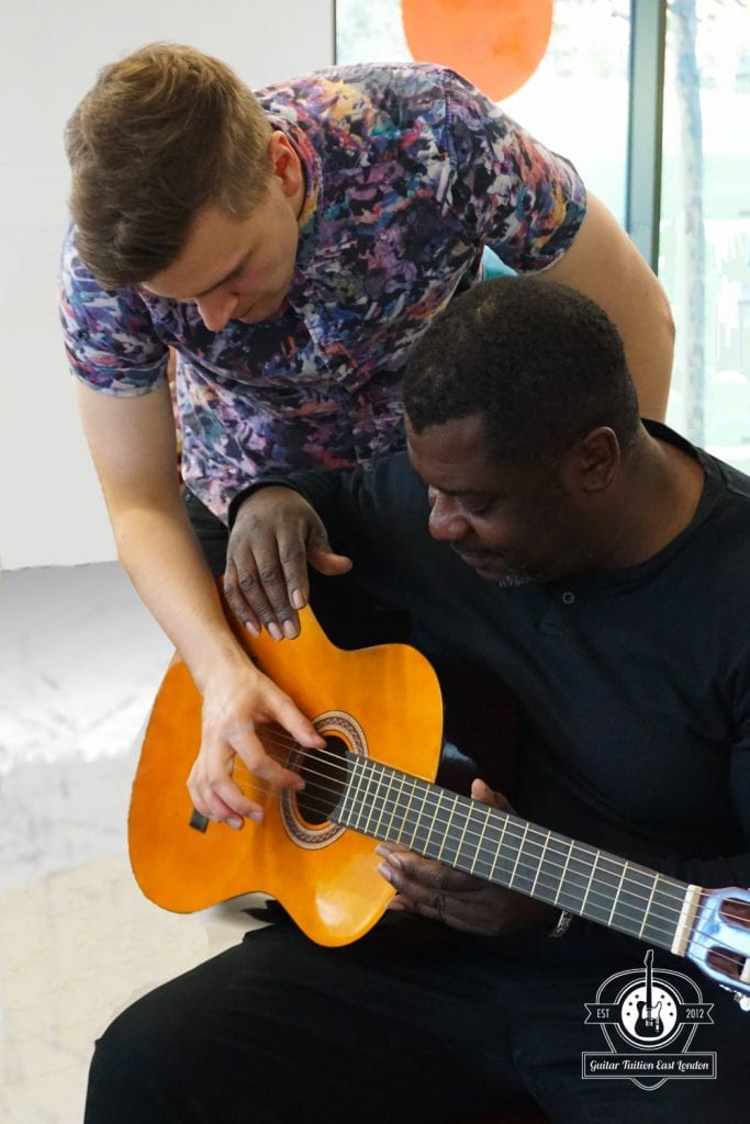 Guitar student with teacher