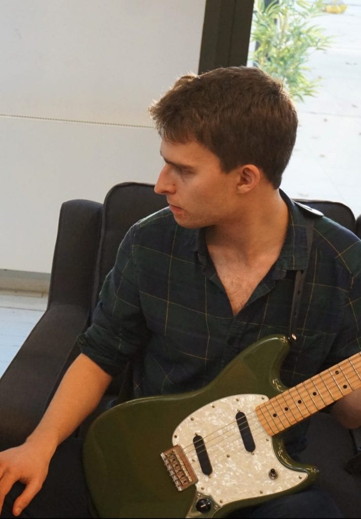 Student and teacher playing guitar in a lesson